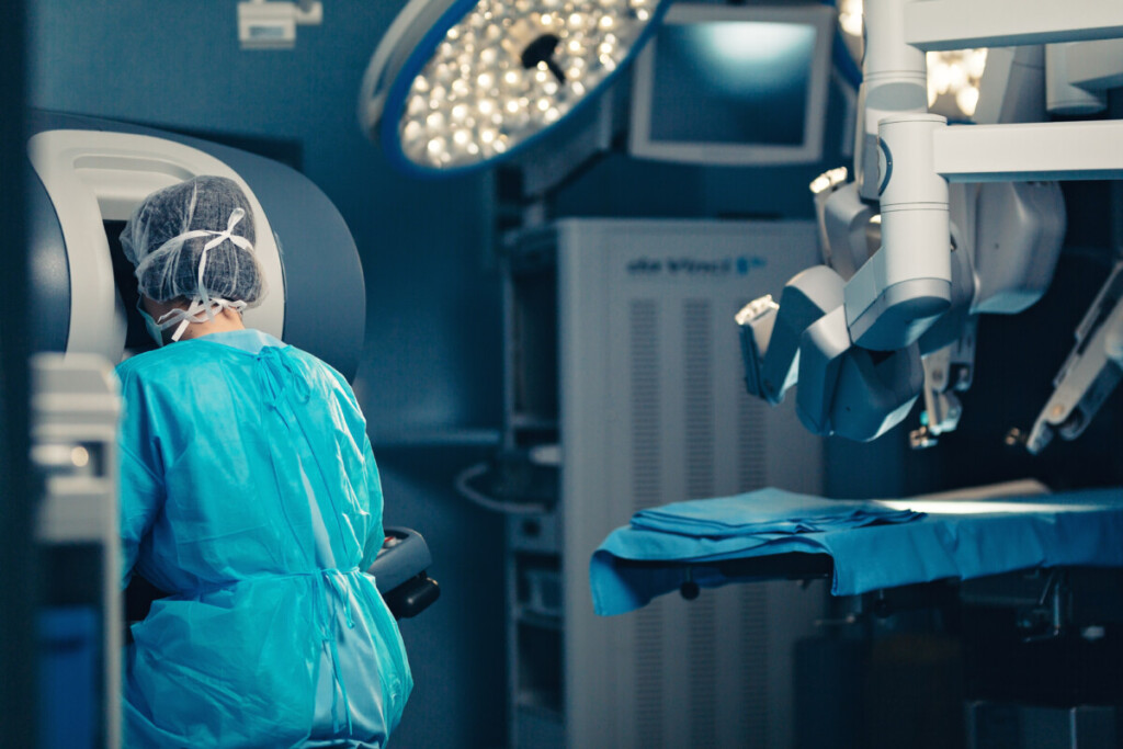 Surgical room in hospital with robotic technology equipment, machine arm surgeon in futuristic operation room. Minimal invasive surgical innovation, medical robot surgery with 3D view endoscopy