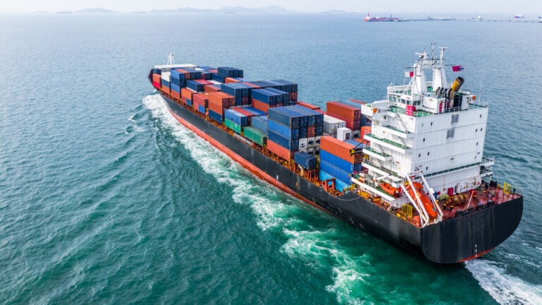 Aerial view cargo container ship sailing, container cargo ship in import export and business logistic and transportation of international by container ship in the open sea. Asset tracking